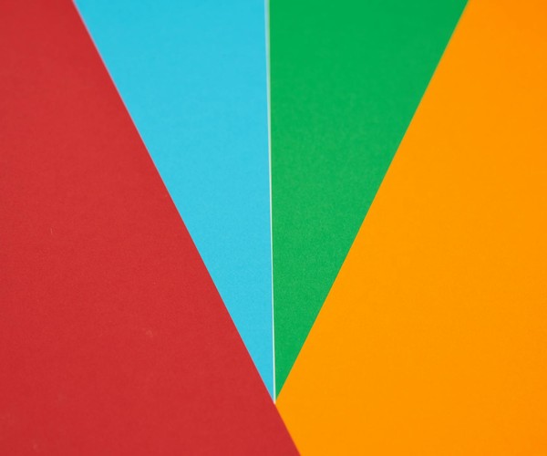 Colorful abstract design featuring red, blue, green, and orange geometric shapes.